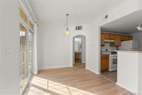 a view of a kitchen with a sink a refrigerator and window