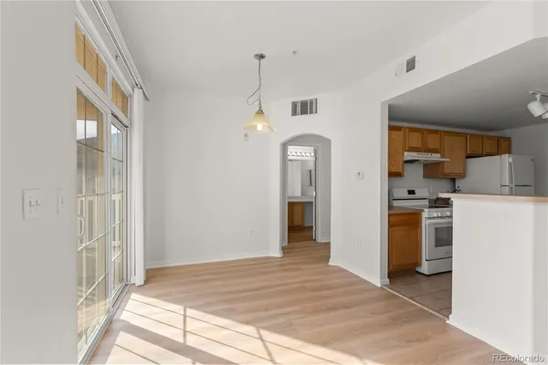 a view of a kitchen with a sink a refrigerator and window