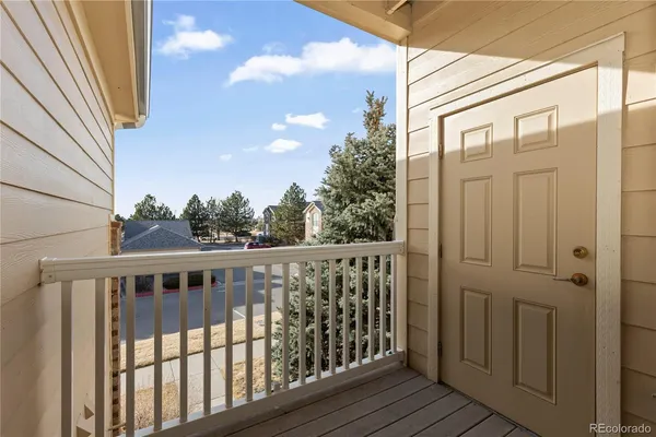 a view of a balcony with wooden floor