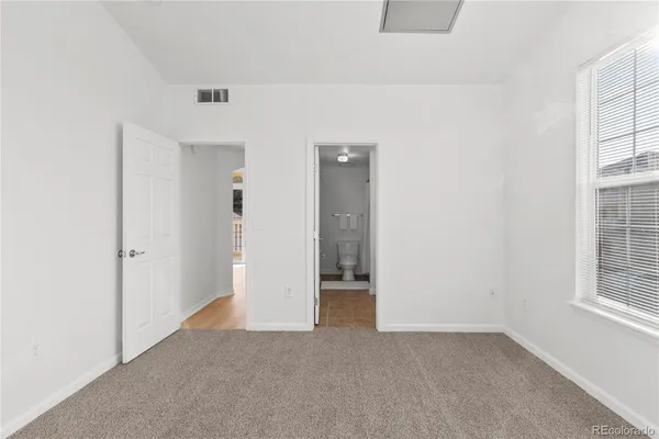 an empty room with windows and closet