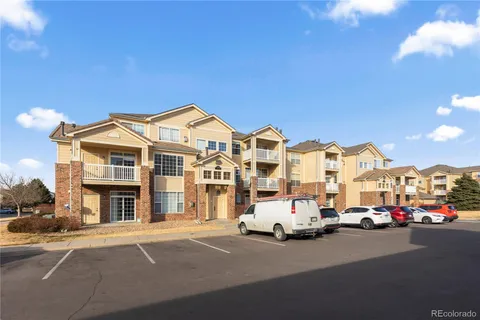 a couple of cars parked in front of a building