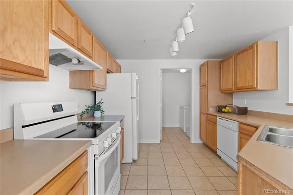 a kitchen with a sink a stove and refrigerator