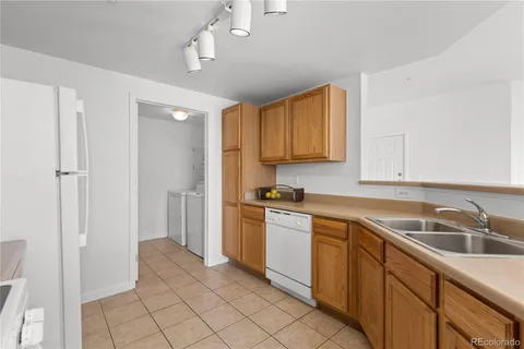 a kitchen with a sink cabinets and appliances