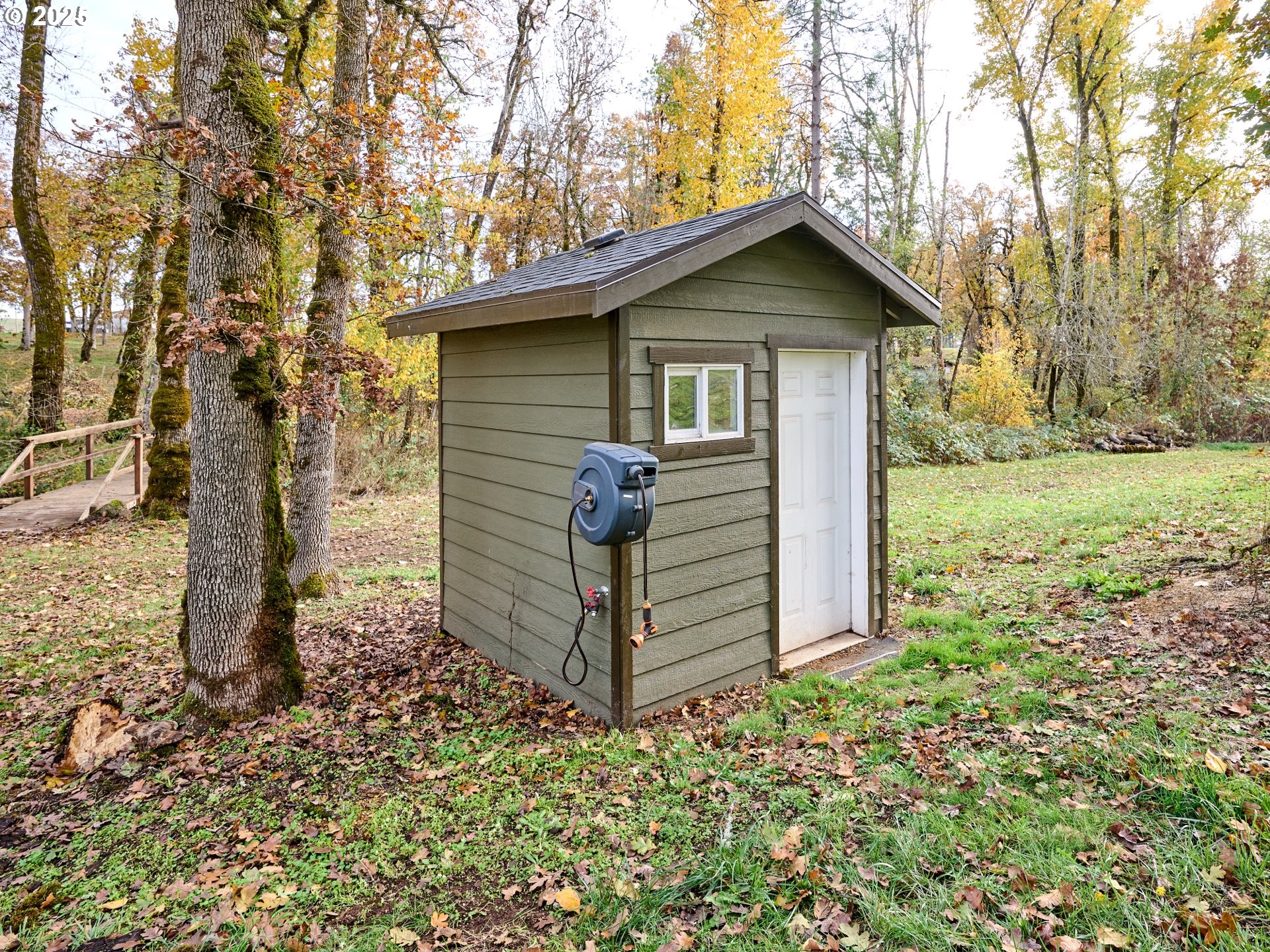 6288 Sherman Road Southeast Aumsville, OR 97325 - Photo 25 of 45 a view of a wooden house with a small yard and large trees
