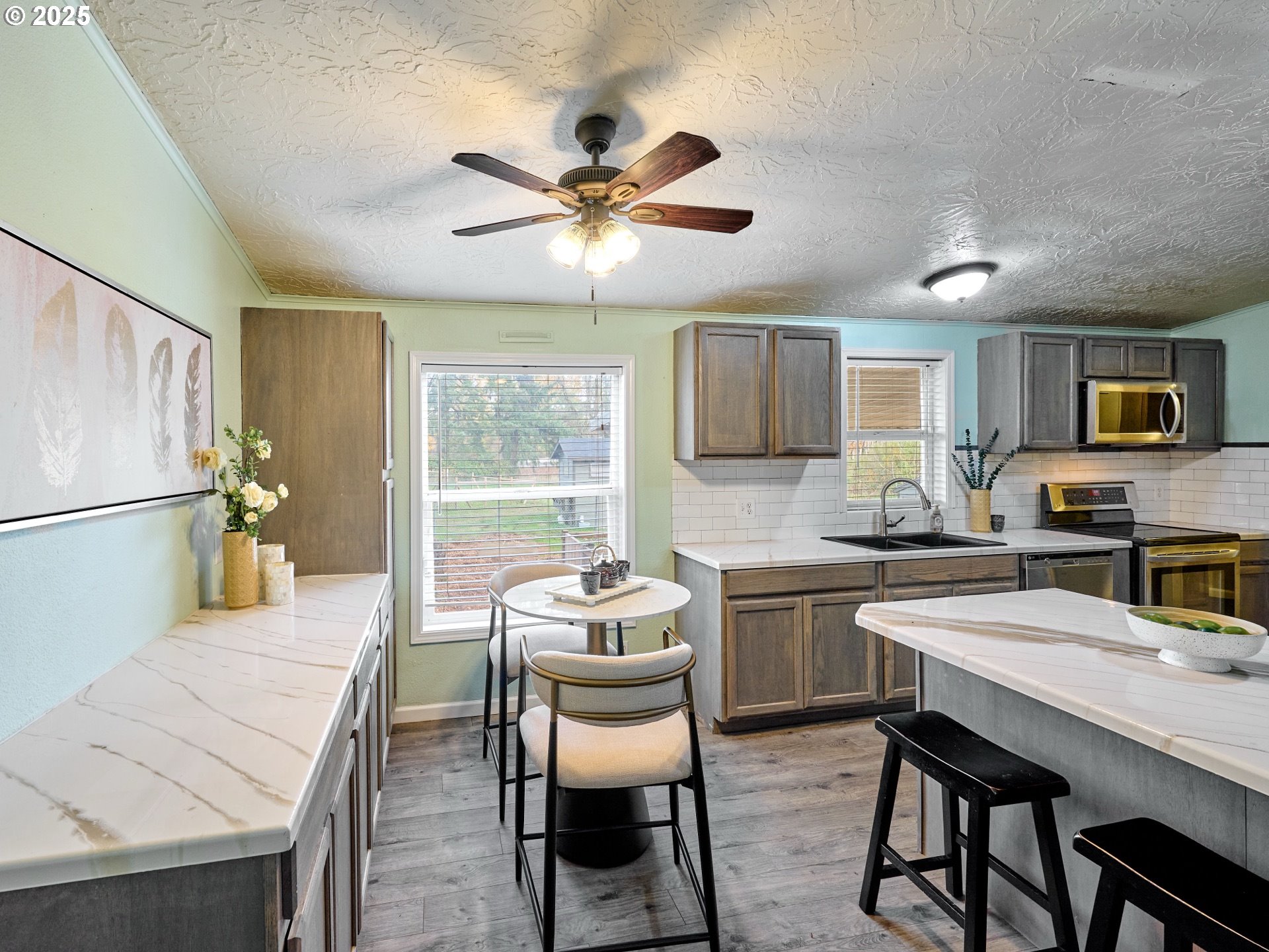 6288 Sherman Road Southeast Aumsville, OR 97325 - Photo 7 of 45 a kitchen with a table chairs microwave and refrigerator