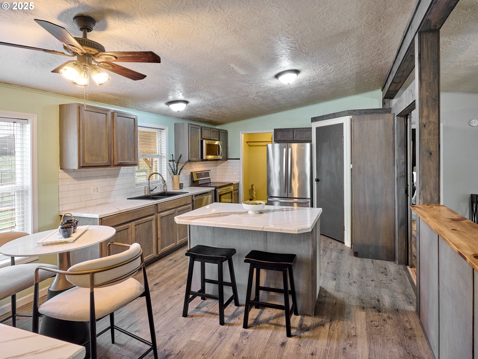 6288 Sherman Road Southeast Aumsville, OR 97325 - Photo 8 of 45 a kitchen with a table chairs refrigerator and cabinets