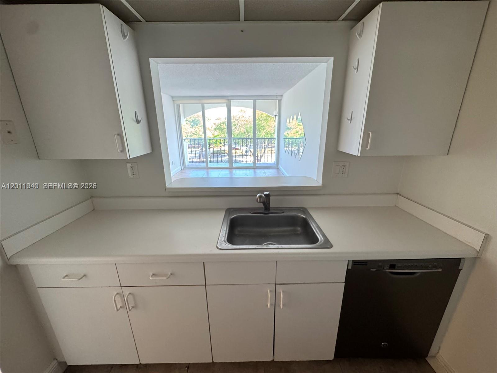 2160 Southwest 16th Avenue, Unit 416 Miami, FL 33145 - Photo 25 of 32 a kitchen with a sink and a window