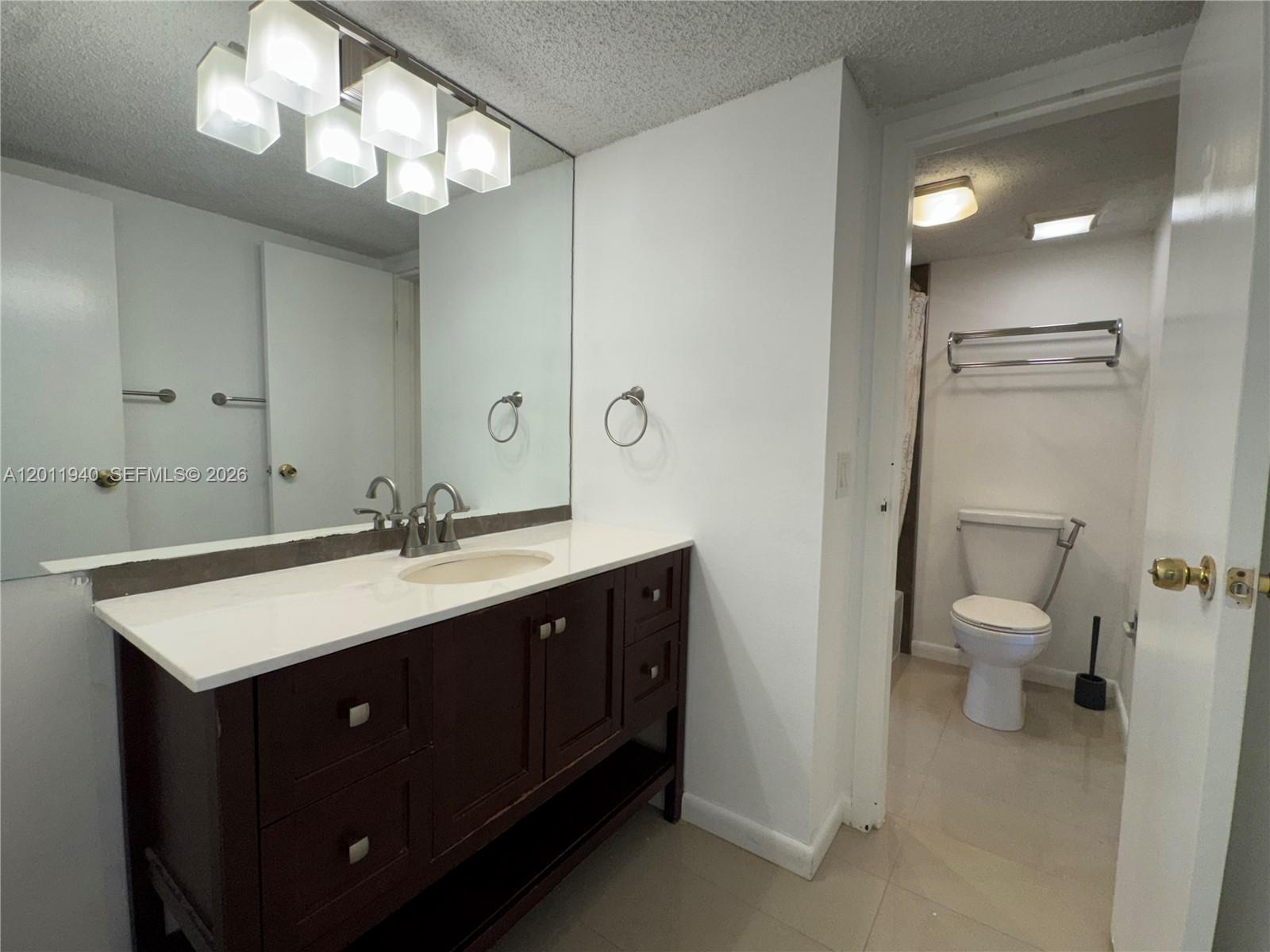 2160 Southwest 16th Avenue, Unit 416 Miami, FL 33145 - Photo 26 of 32 a bathroom with a sink vanity and a mirror