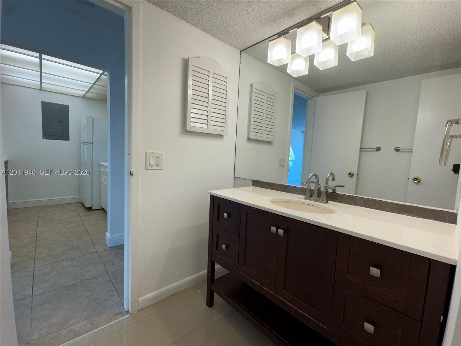 2160 Southwest 16th Avenue, Unit 416 Miami, FL 33145 - Photo 27 of 32 a bathroom with a double vanity sink and a mirror