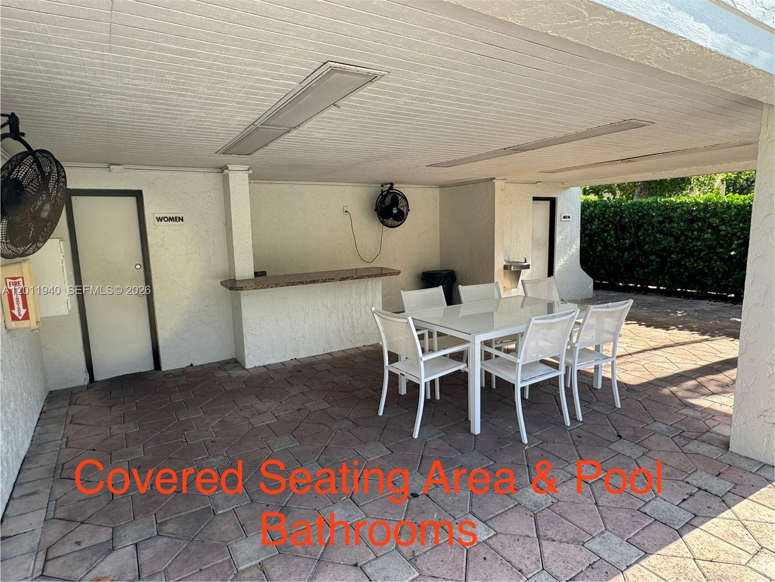 2160 Southwest 16th Avenue, Unit 416 Miami, FL 33145 - Photo 5 of 32 a view of a patio with table and chairs with wooden floor and fence