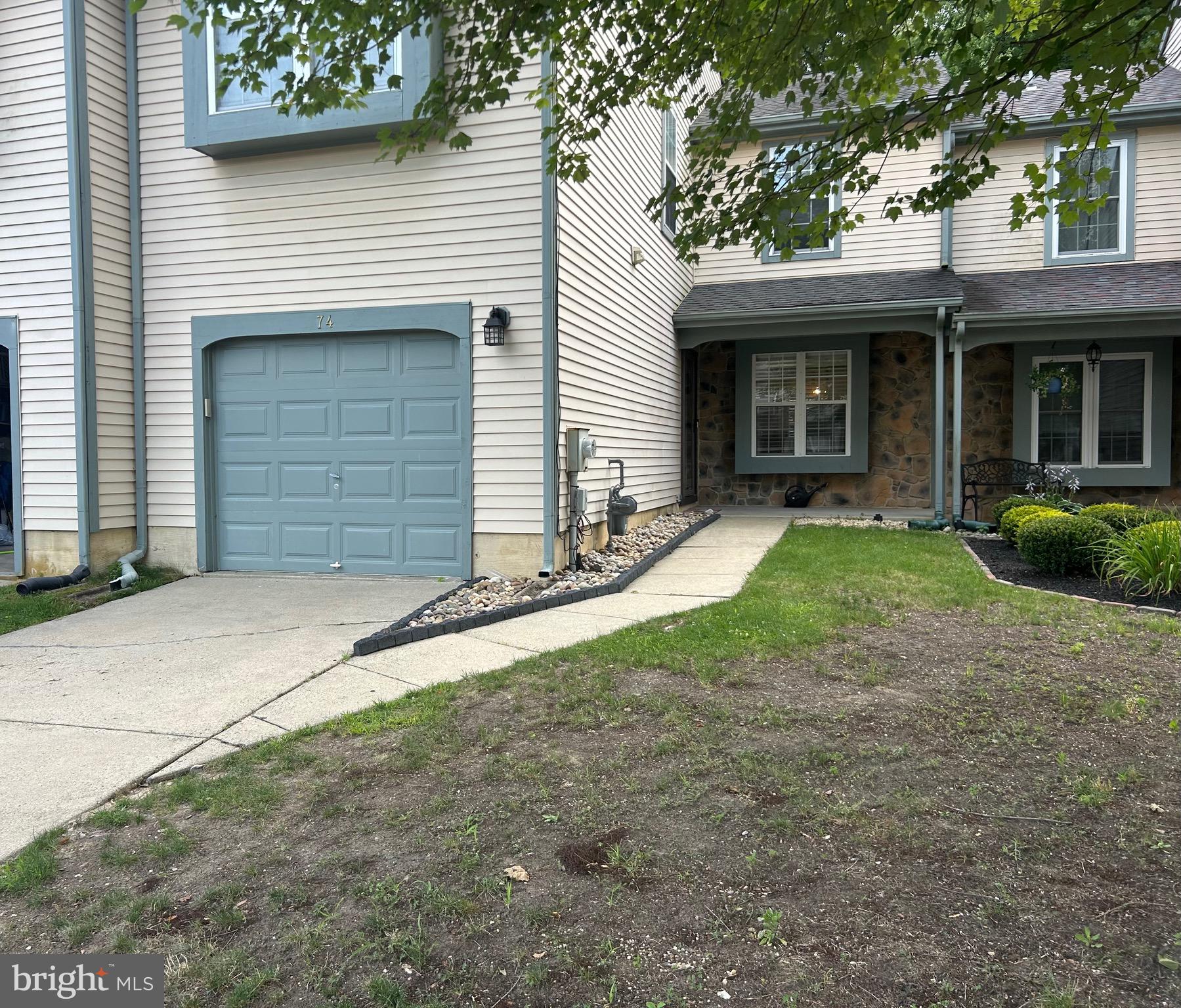 74 Kettlebrook Drive Mount Laurel, NJ 08054 - Photo 2 of 29 a front view of a house with a yard and garage