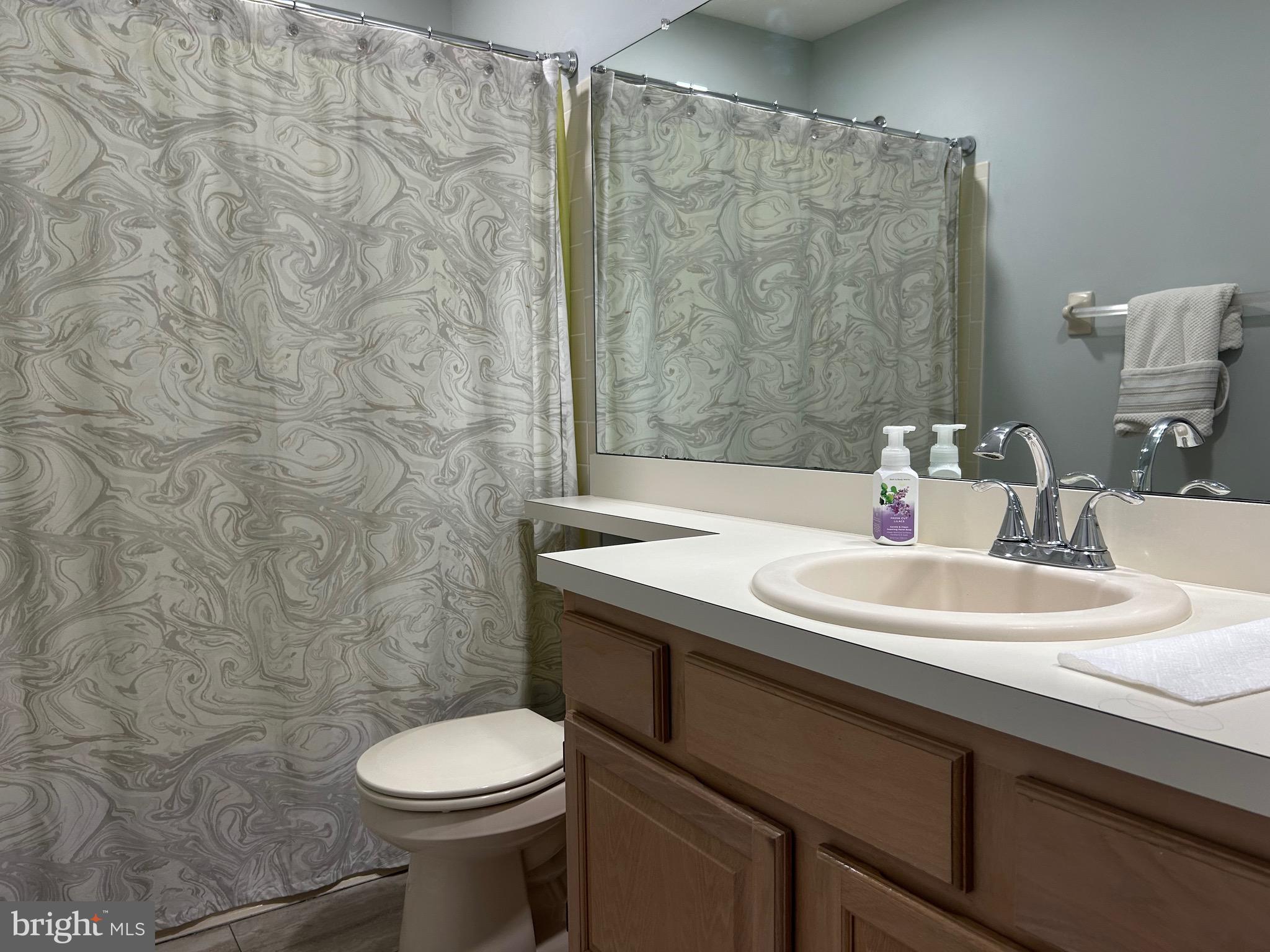 74 Kettlebrook Drive Mount Laurel, NJ 08054 - Photo 22 of 29 a bathroom with a sink a toilet and a mirror