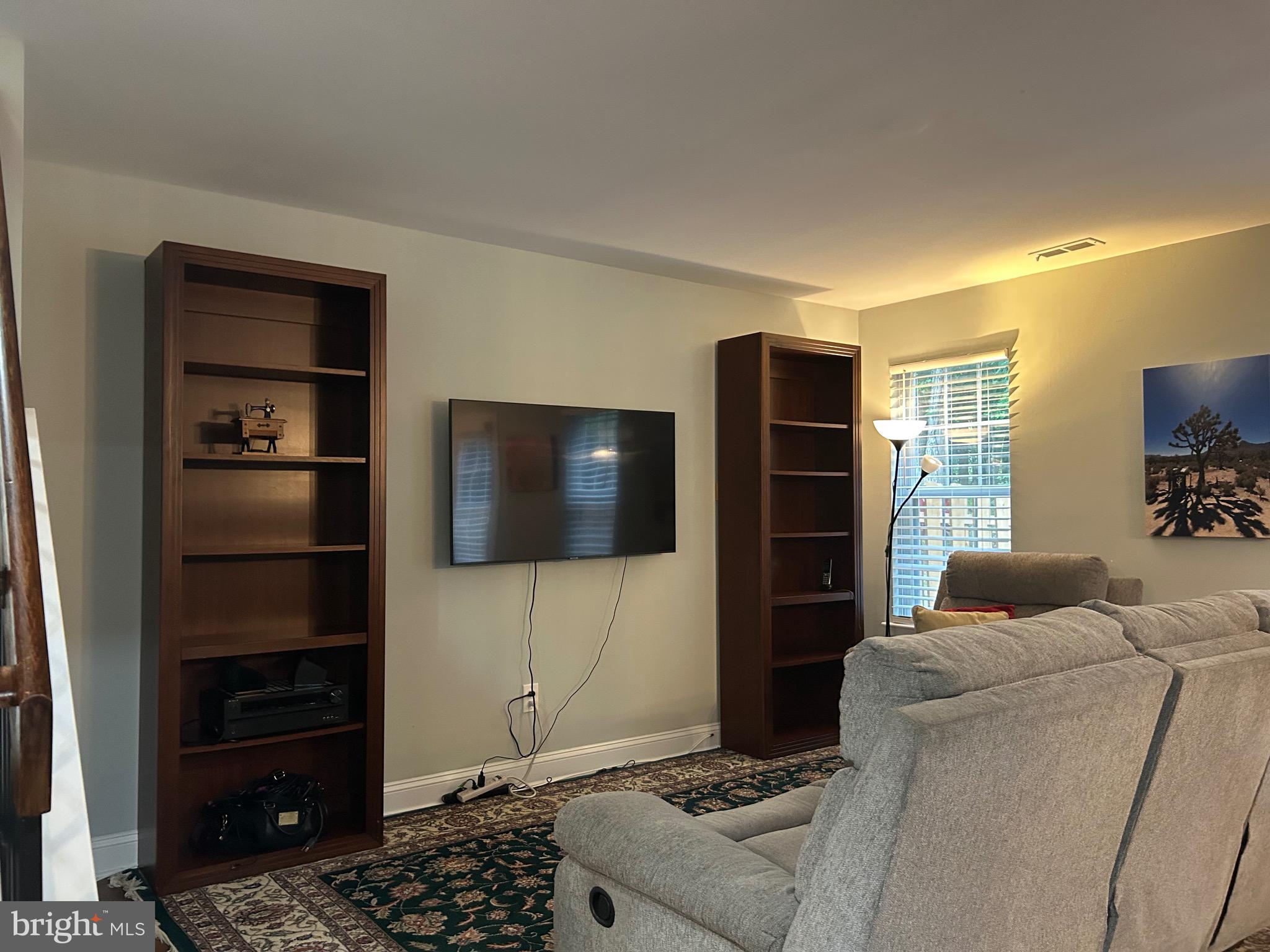 74 Kettlebrook Drive Mount Laurel, NJ 08054 - Photo 7 of 29 a living room with a flat screen tv and a refrigerator