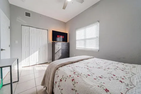 a bedroom with a bed and a chandelier