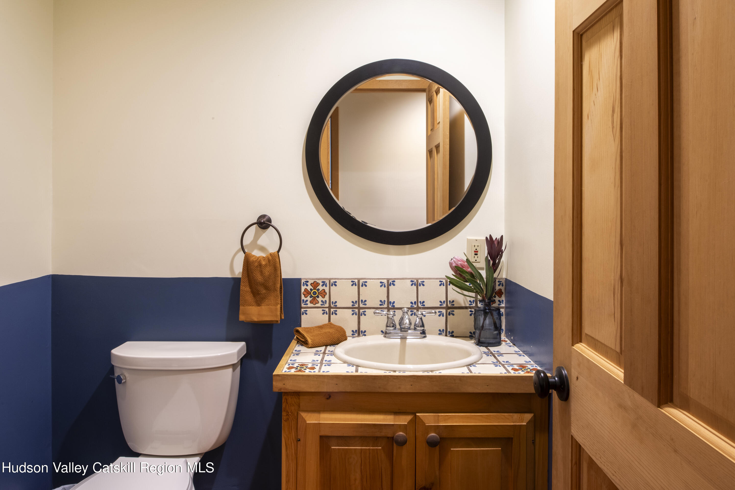 70 Duck Pond Road Stone Ridge, NY 12484 - Photo 13 of 25 a bathroom with a sink a toilet and a mirror