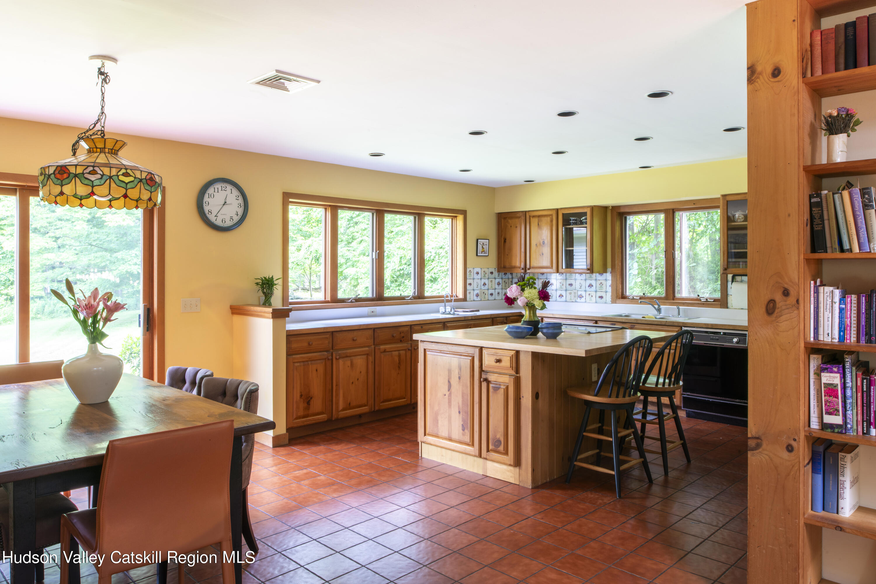70 Duck Pond Road Stone Ridge, NY 12484 - Photo 5 of 25 a kitchen with granite countertop a dining table chairs and a view of living room