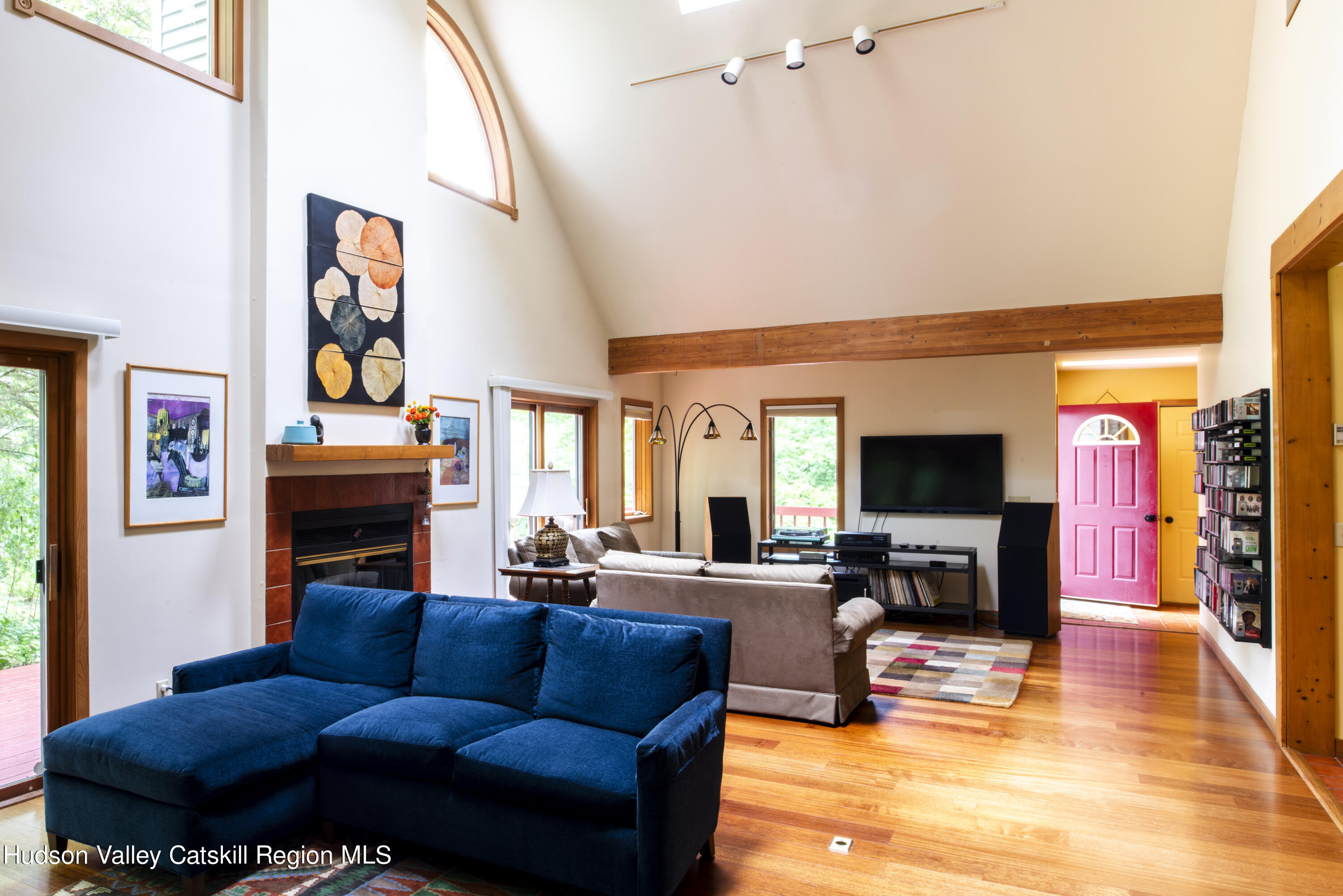70 Duck Pond Road Stone Ridge, NY 12484 - Photo 9 of 25 a living room with fireplace furniture and a flat screen tv