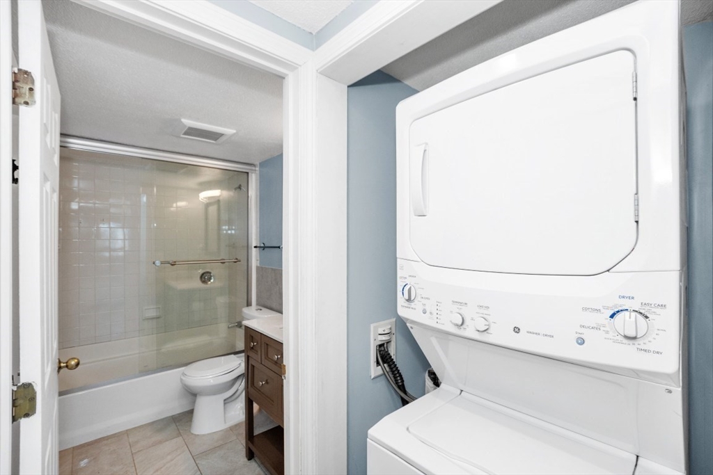 165 Cottage Street, Unit 410 Chelsea, MA 02150 - Photo 12 of 25 a bathroom with a toilet a sink and shower
