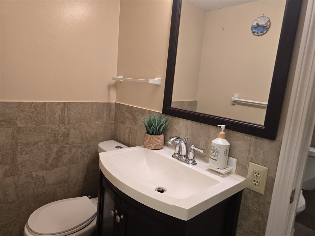 165 Cottage Street, Unit 410 Chelsea, MA 02150 - Photo 13 of 25 a bathroom with a sink a toilet and mirror