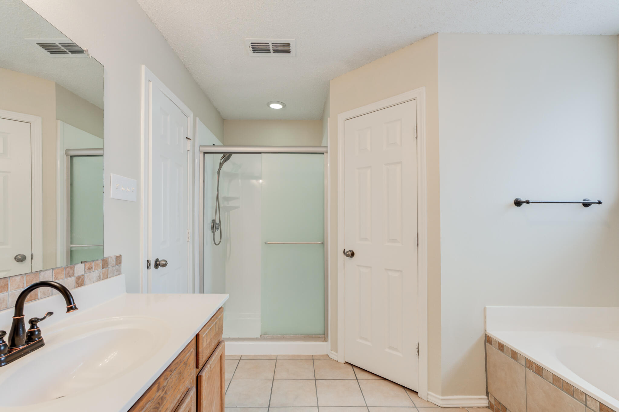 6713 85th Street Lubbock, TX 79424 - Photo 11 of 16 a bathroom with a sink and a mirror