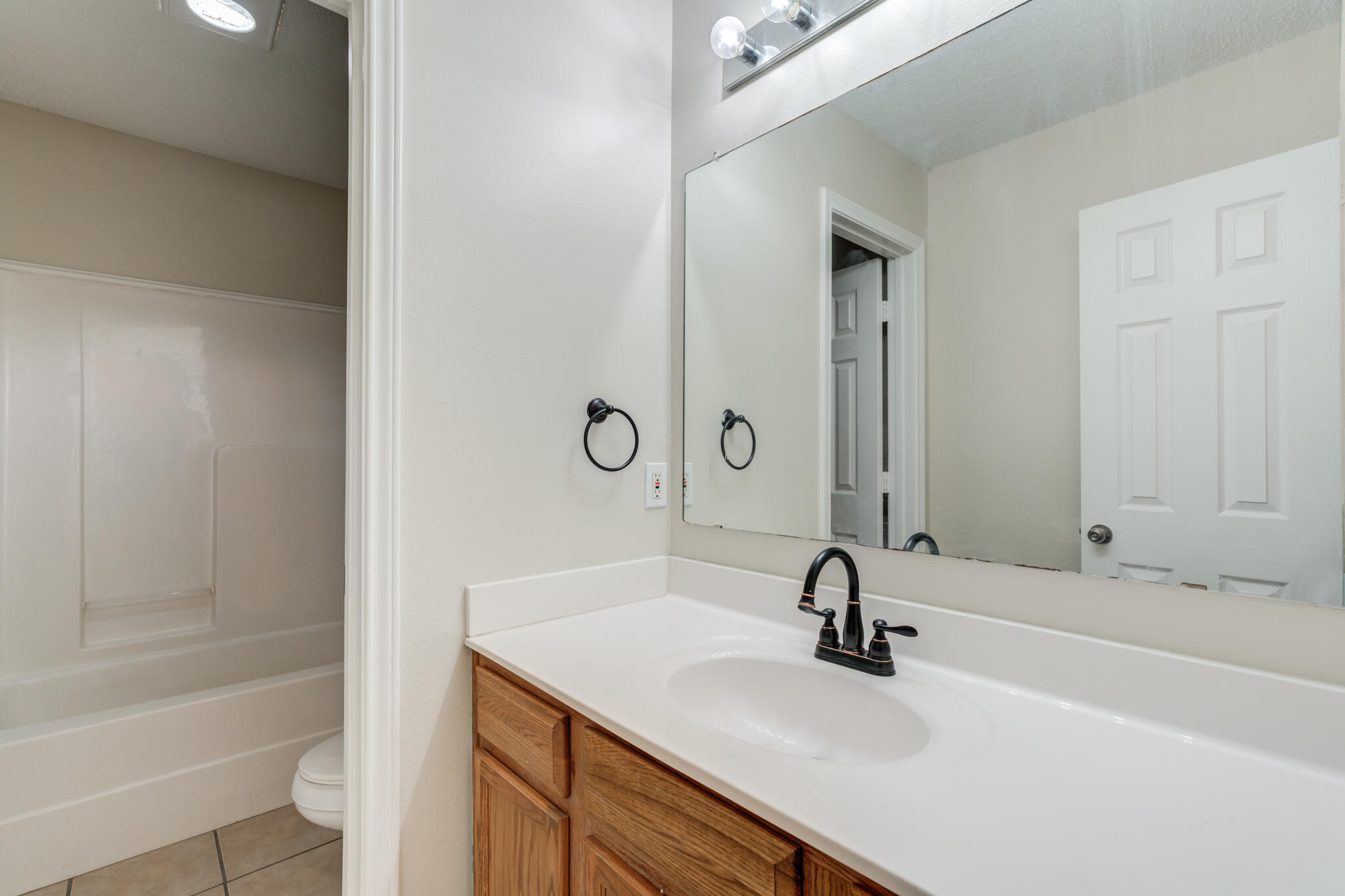 6713 85th Street Lubbock, TX 79424 - Photo 13 of 16 a bathroom with a sink and a bathtub
