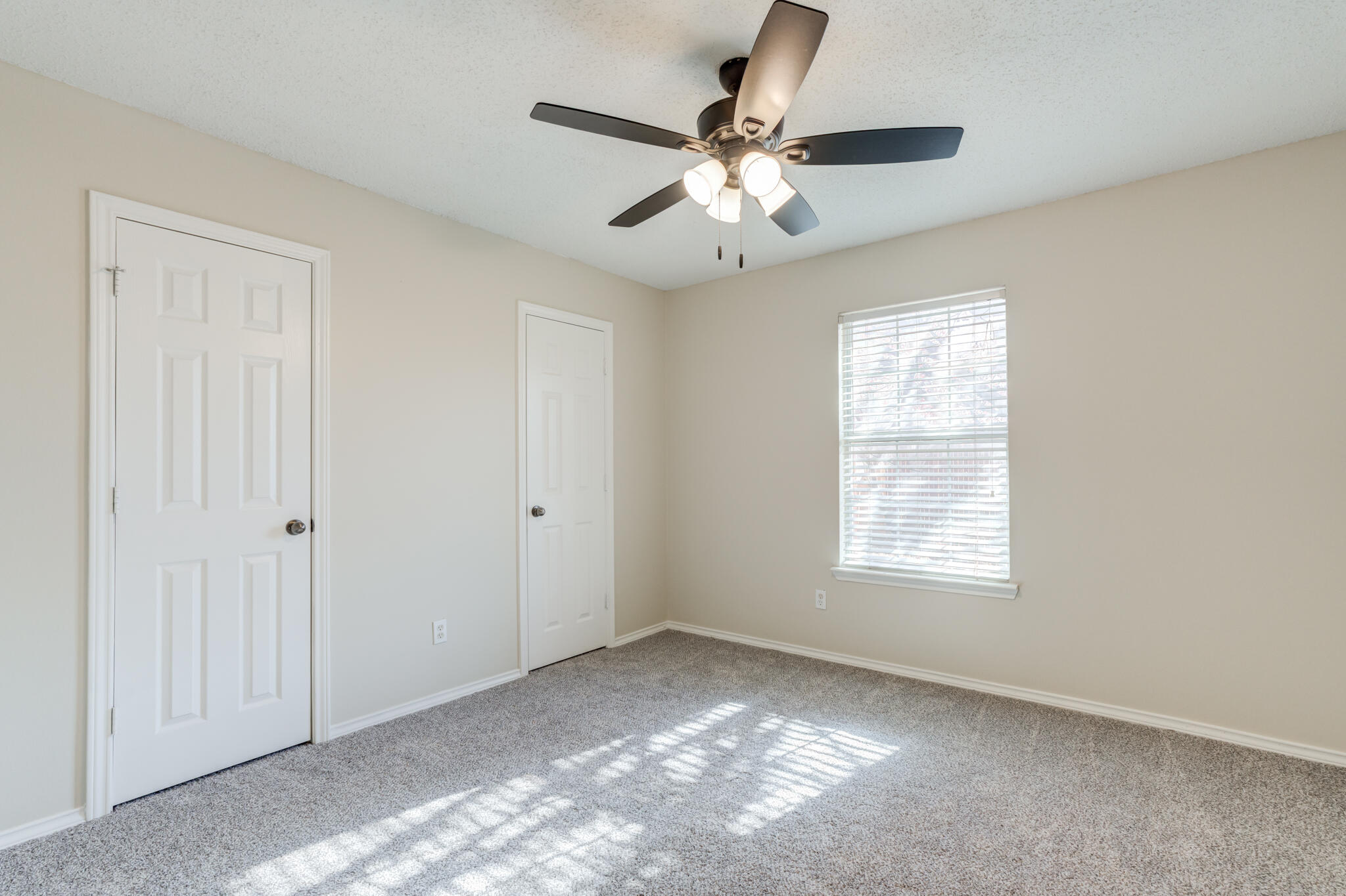 6713 85th Street Lubbock, TX 79424 - Photo 15 of 16 an empty room with windows and fan