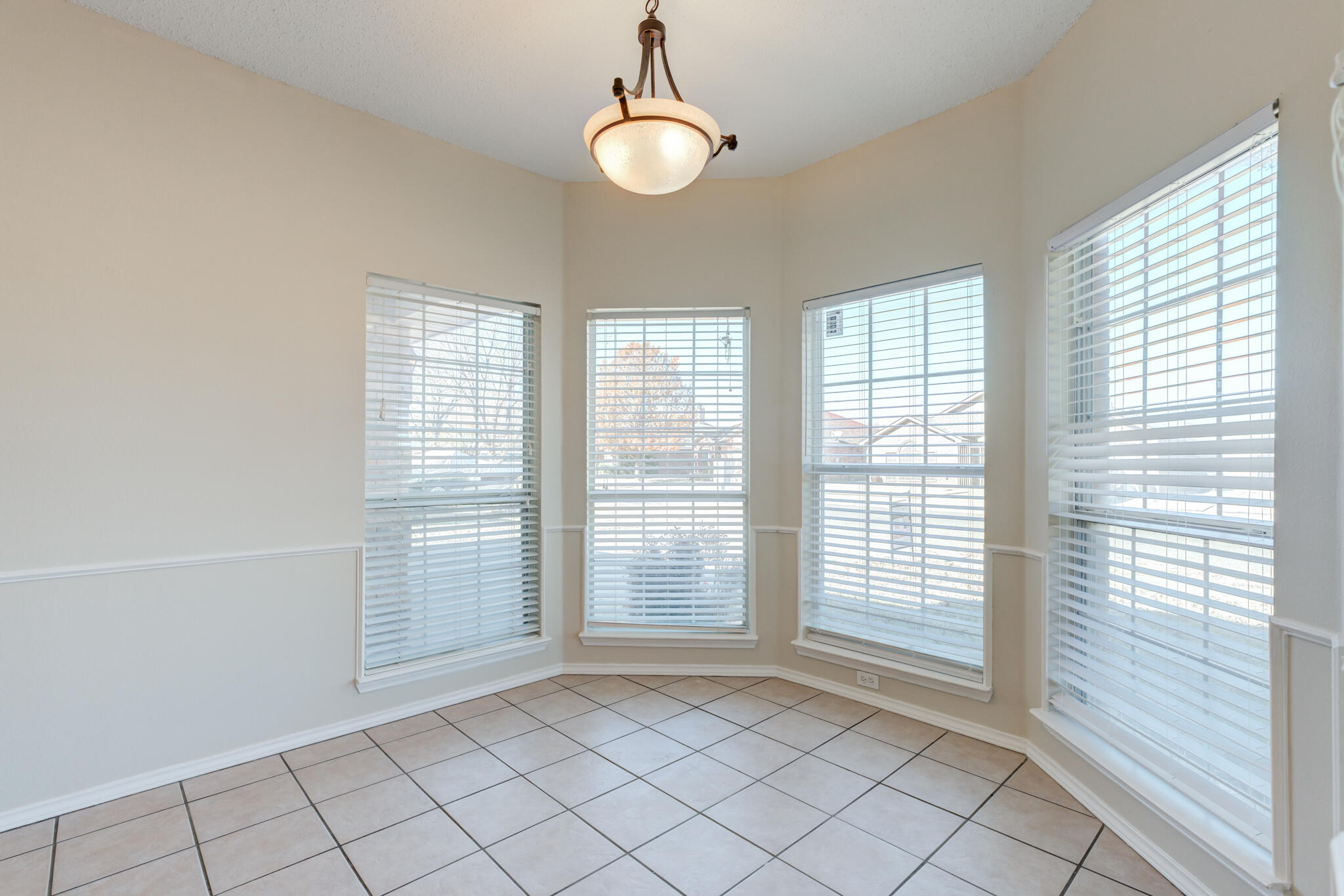 6713 85th Street Lubbock, TX 79424 - Photo 2 of 16 a view of an empty room with window chandelier