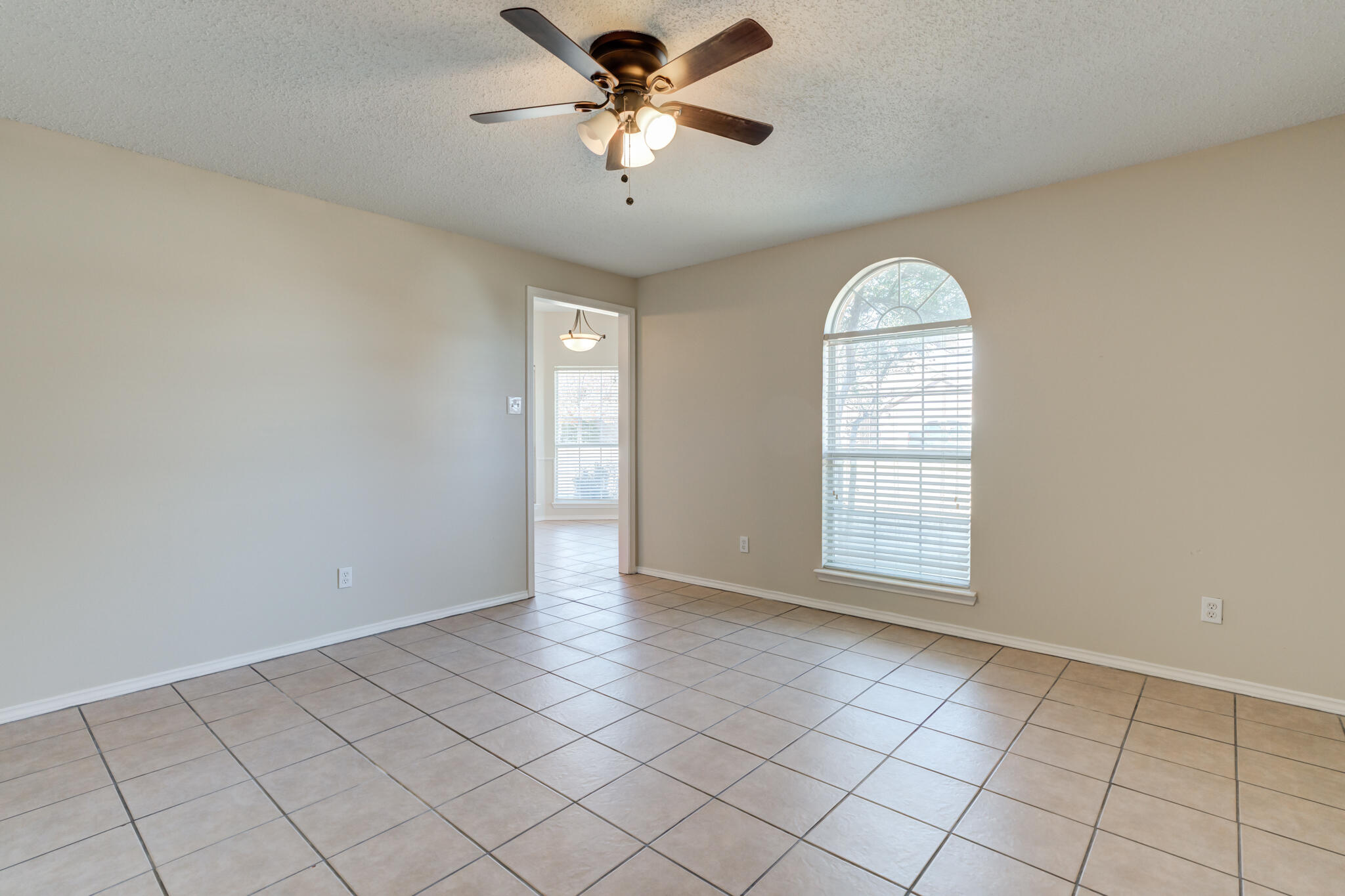 6713 85th Street Lubbock, TX 79424 - Photo 4 of 16 a view of an empty room with a window
