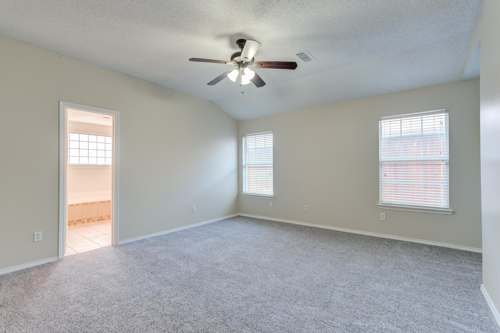 6713 85th Street Lubbock, TX 79424 - Photo 8 of 16 a view of an empty room with a window