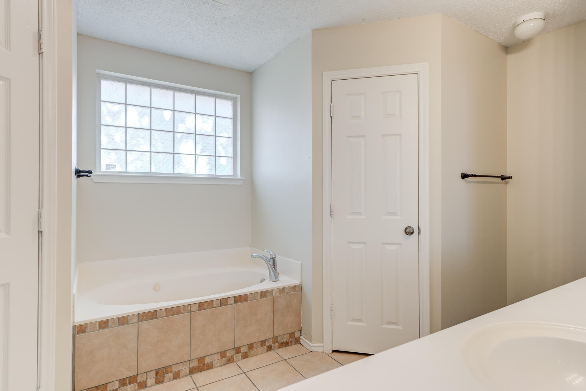 6713 85th Street Lubbock, TX 79424 - Photo 10 of 16 a bathroom with a bathtub and shower
