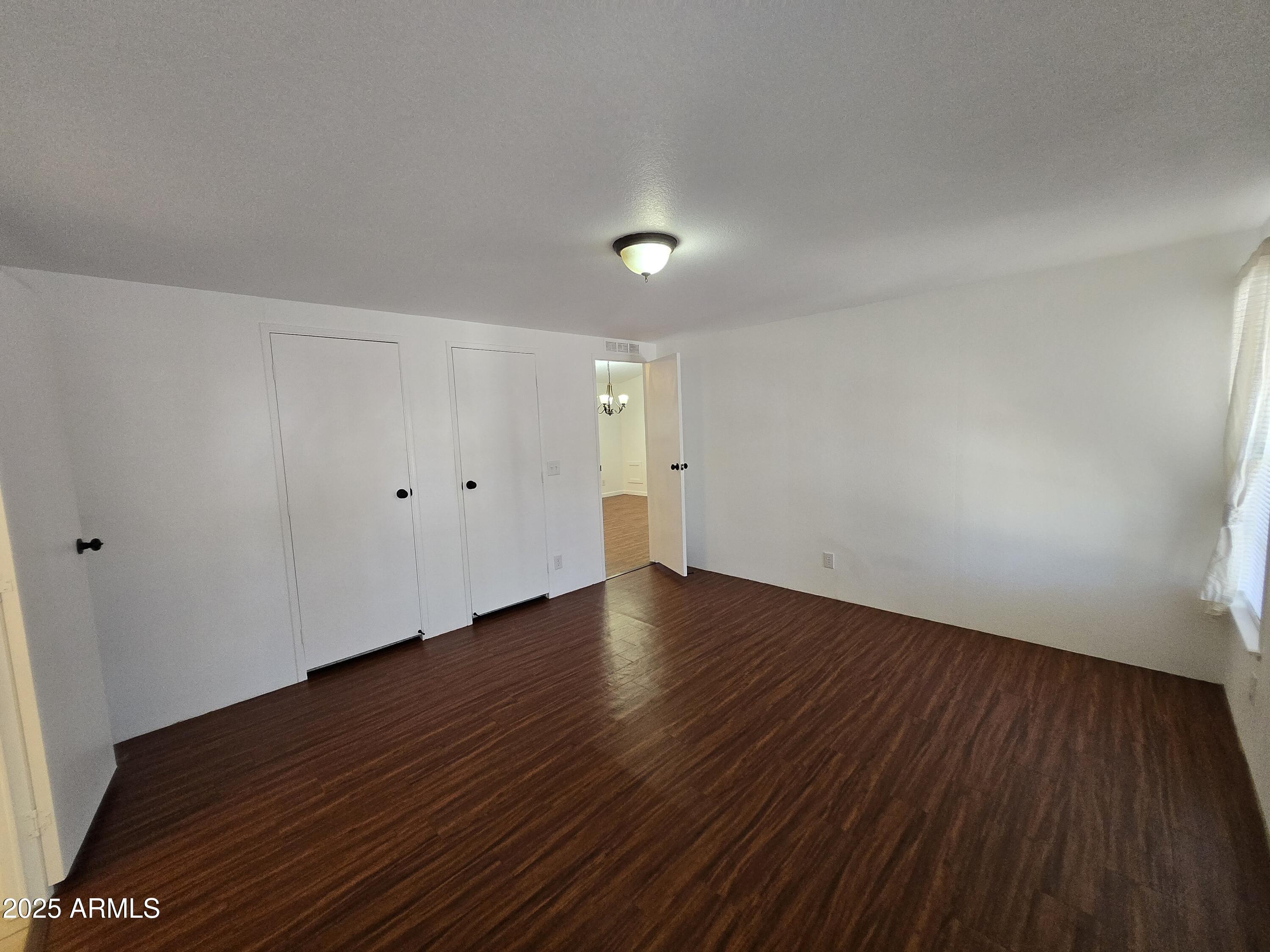 2000 South Apache Road, Unit 87 Buckeye, AZ 85326 - Photo 13 of 29 a view of wooden floor and windows in a room