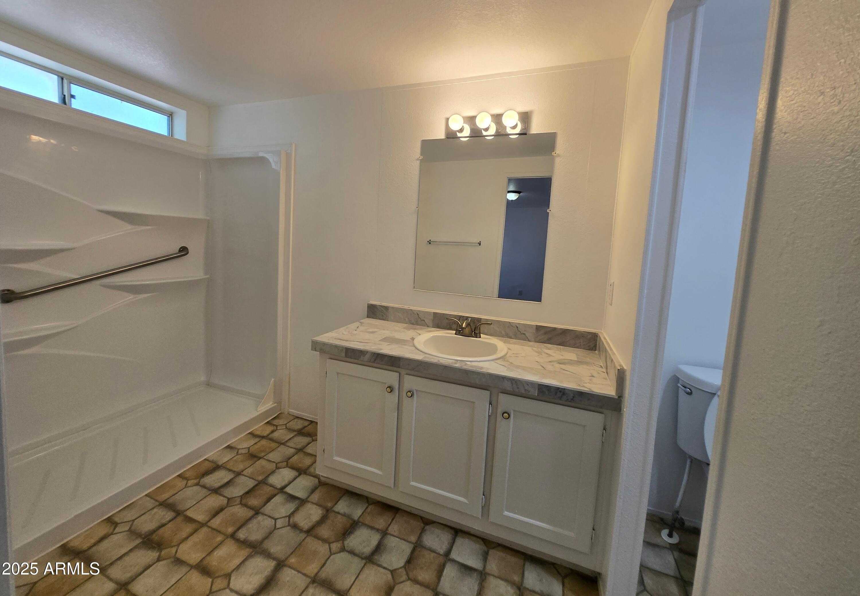 2000 South Apache Road, Unit 87 Buckeye, AZ 85326 - Photo 15 of 29 a bathroom with a sink and a mirror