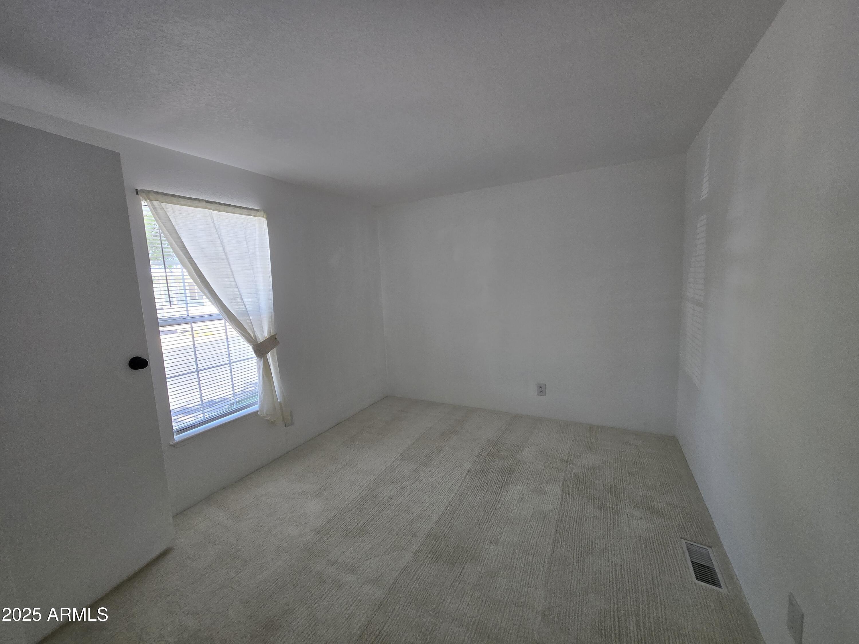 2000 South Apache Road, Unit 87 Buckeye, AZ 85326 - Photo 18 of 29 an empty room with windows