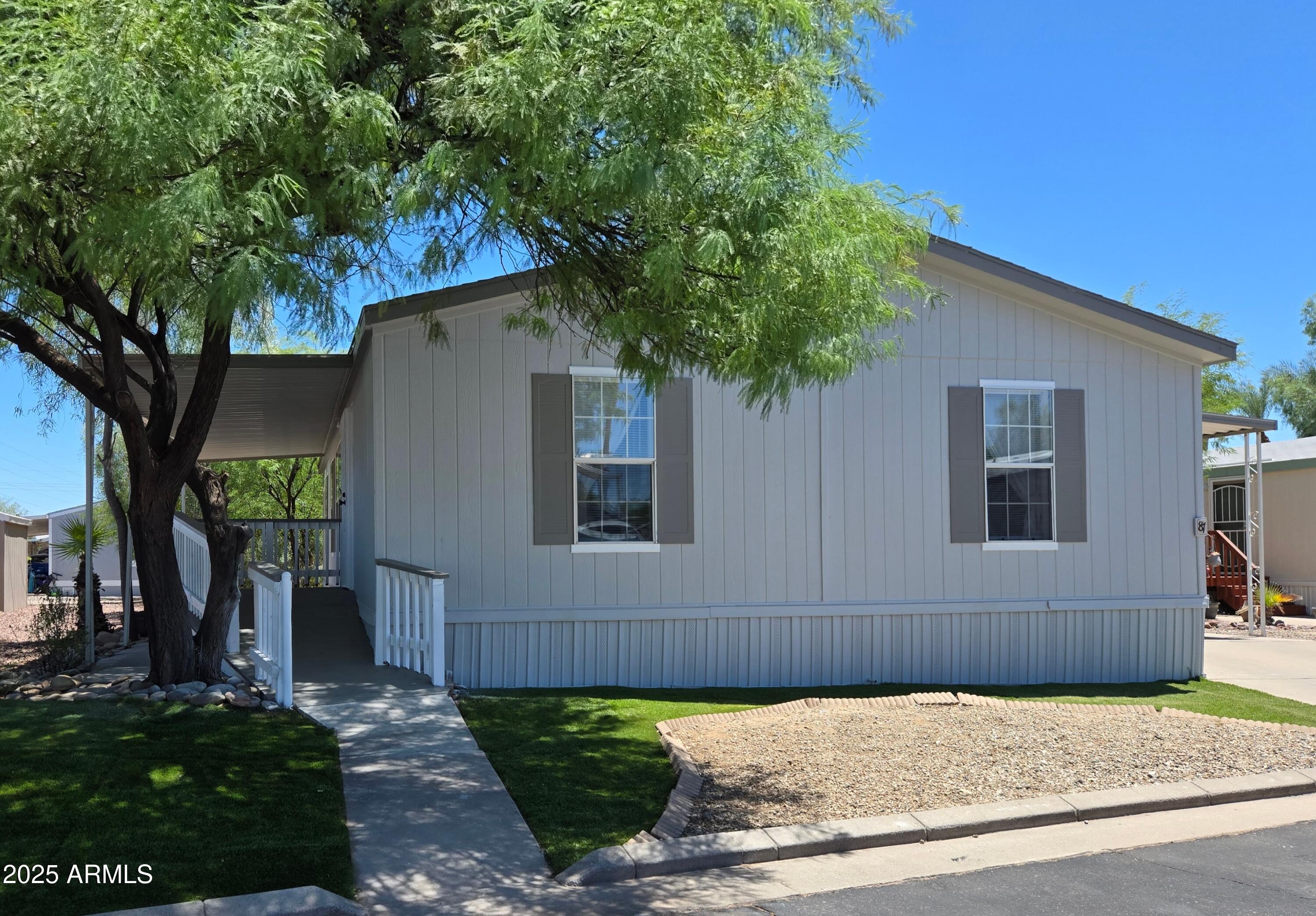 2000 South Apache Road, Unit 87 Buckeye, AZ 85326 - Photo 2 of 29 a front view of a house with garden