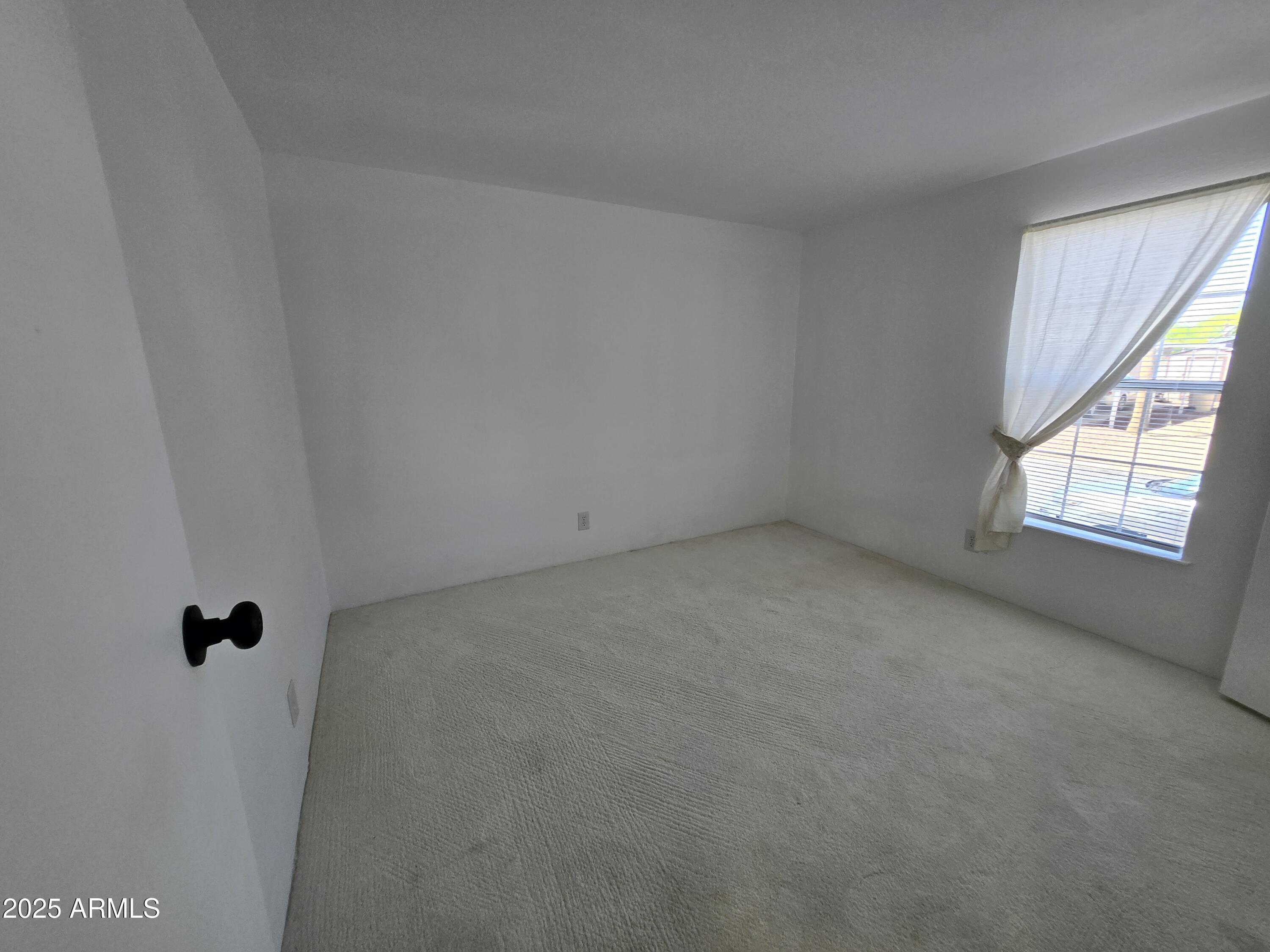 2000 South Apache Road, Unit 87 Buckeye, AZ 85326 - Photo 21 of 29 a view of an empty room with a window