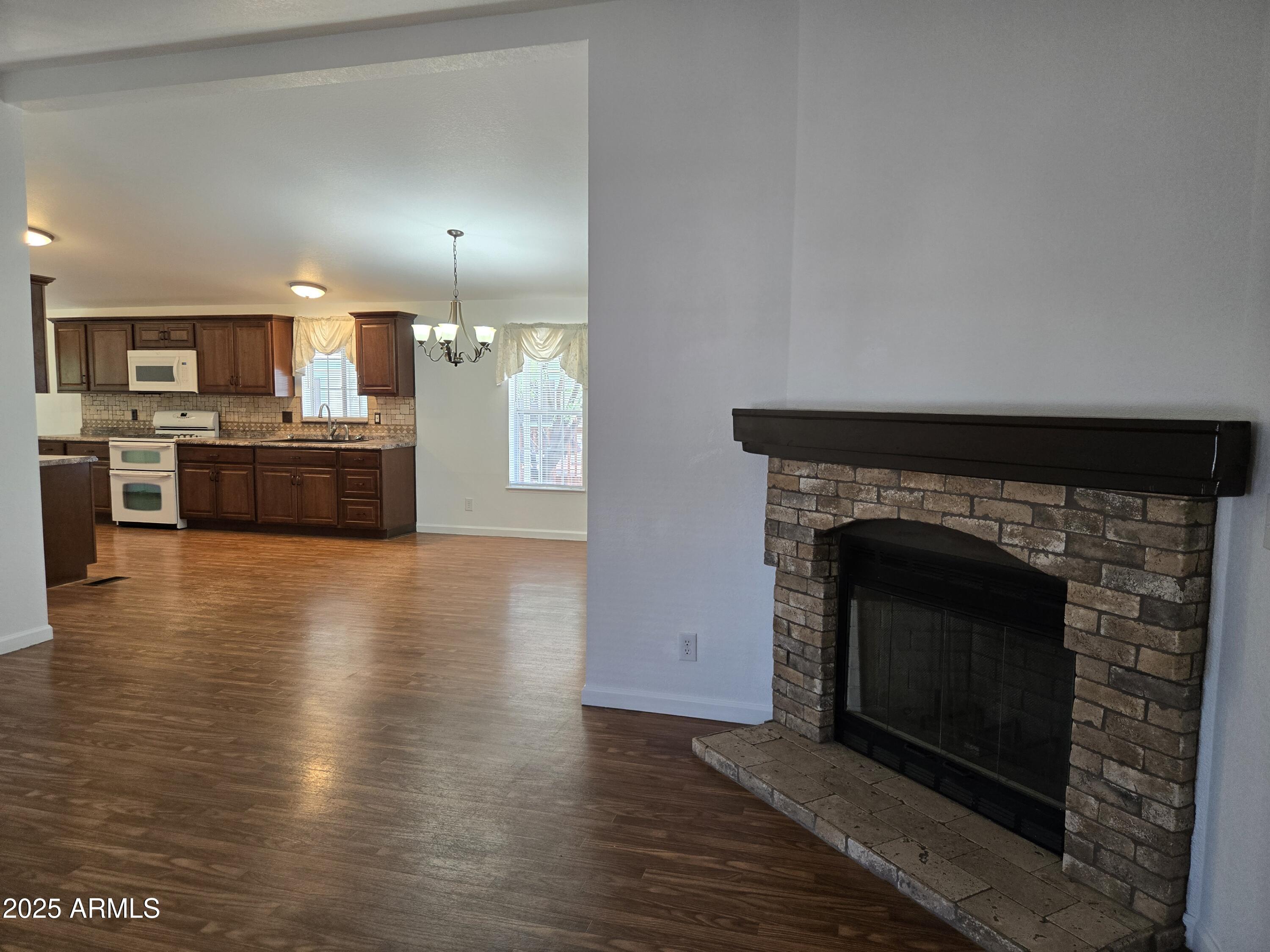 2000 South Apache Road, Unit 87 Buckeye, AZ 85326 - Photo 6 of 29 a kitchen with a stove and a fireplace