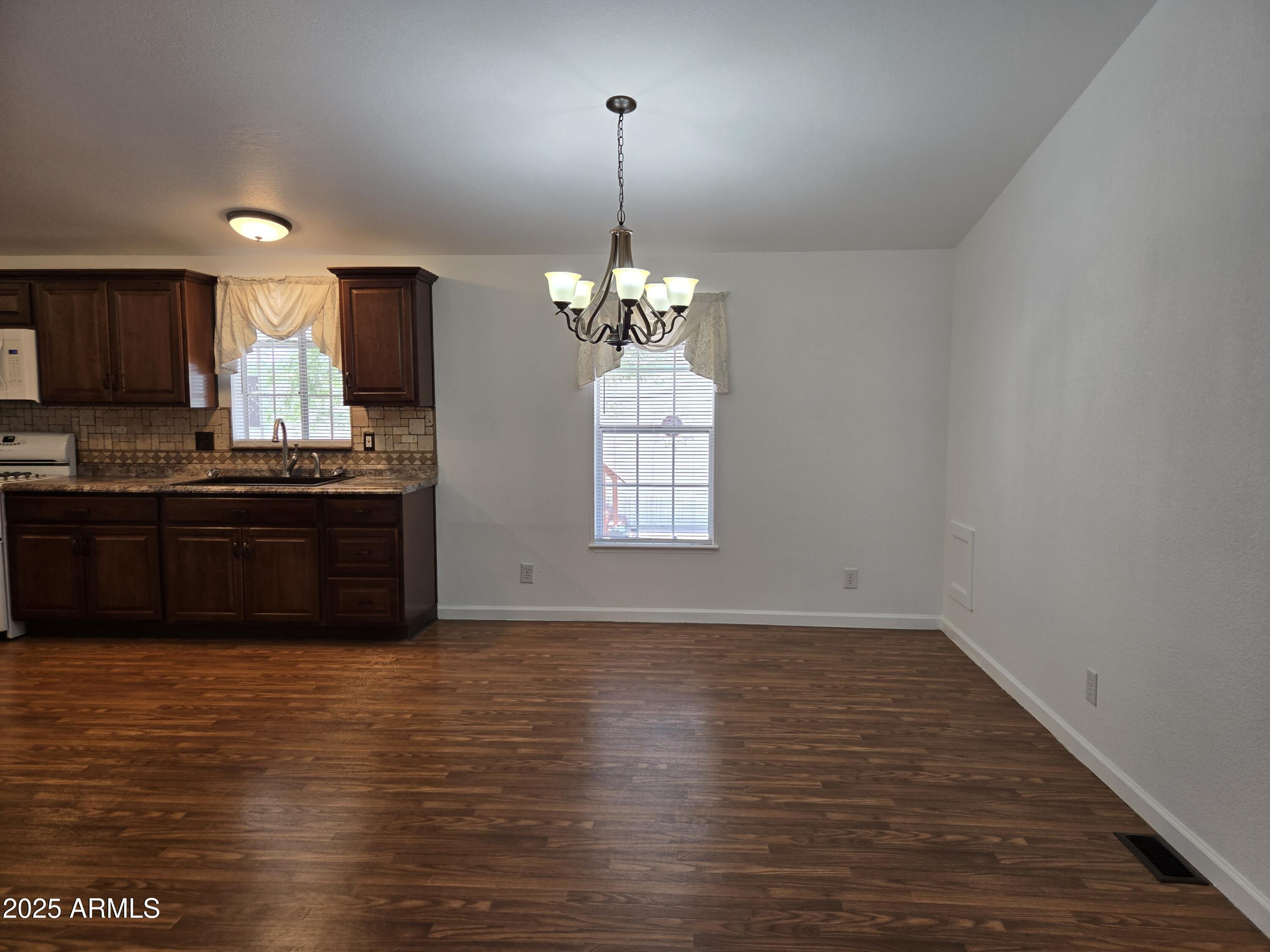 2000 South Apache Road, Unit 87 Buckeye, AZ 85326 - Photo 7 of 29 a view of kitchen and kitchen with sink wooden floor and window