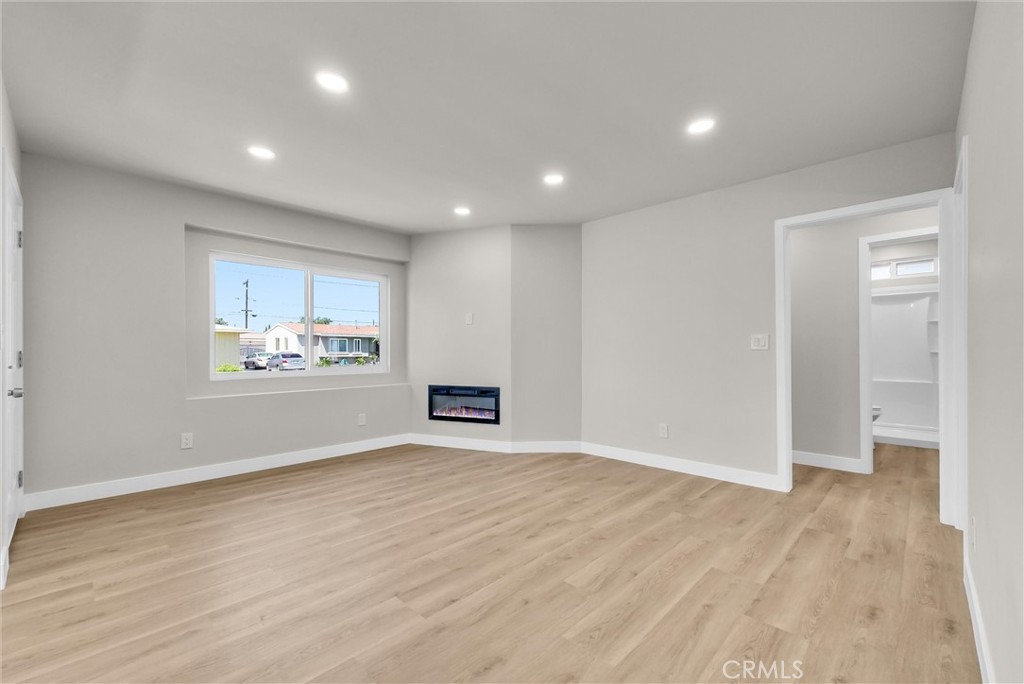 2264 Cogswell Road El Monte, CA 91732 - Photo 5 of 26 a view of an empty room with wooden floor and a window