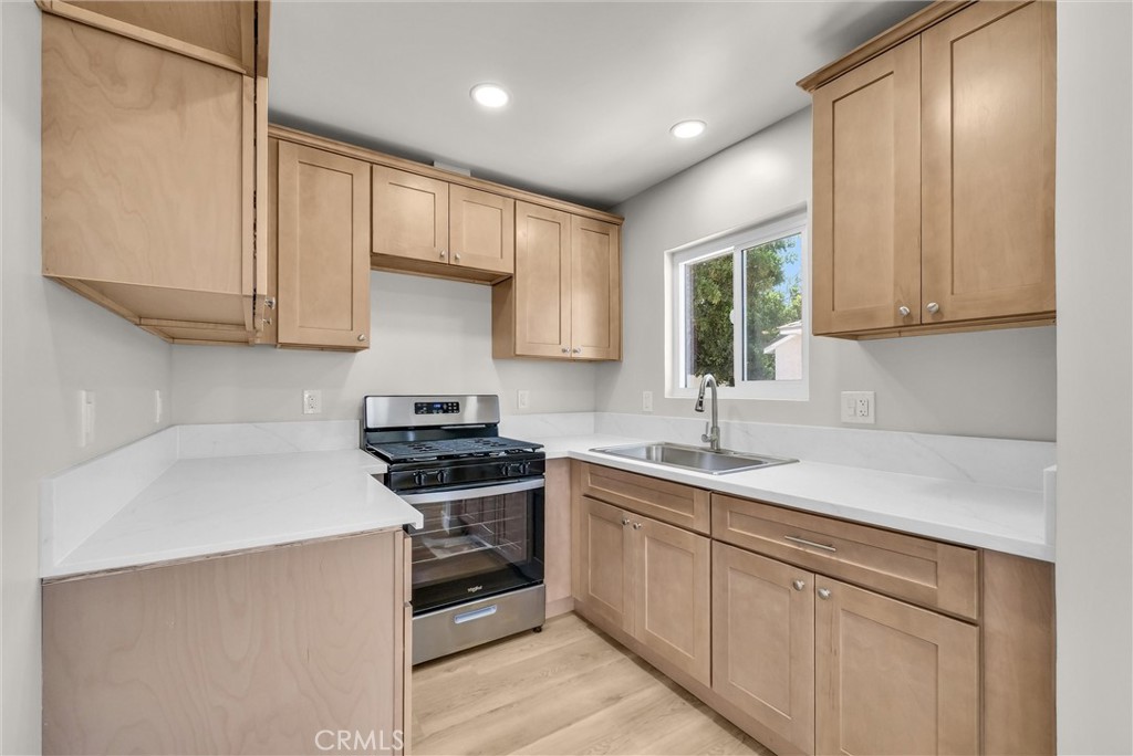 2264 Cogswell Road El Monte, CA 91732 - Photo 10 of 26 a kitchen with a sink stove and cabinets