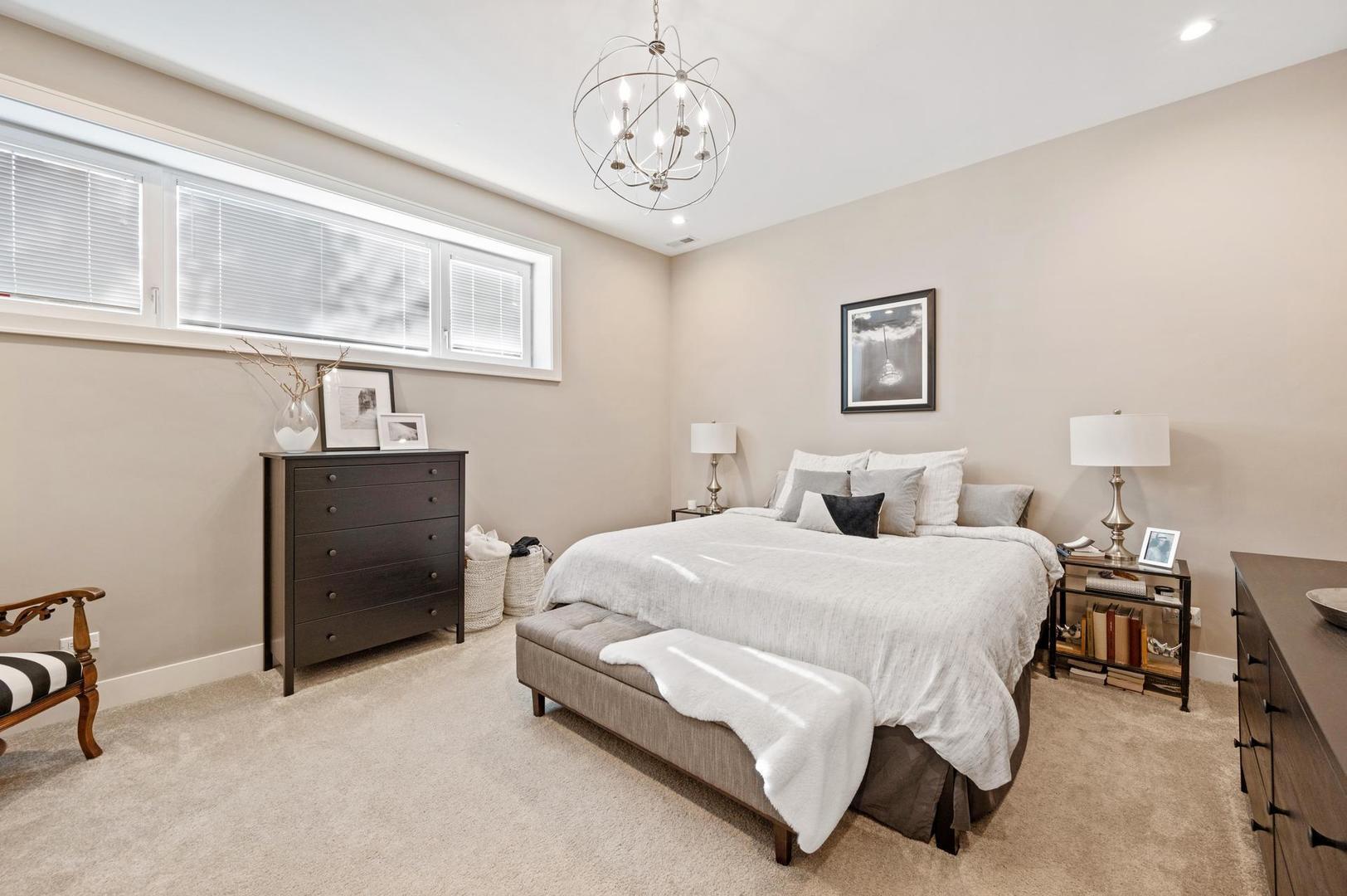 832 West Cullerton Street, Unit 1W Chicago, IL 60608 - Photo 11 of 14 a bedroom with a bed and a chandelier