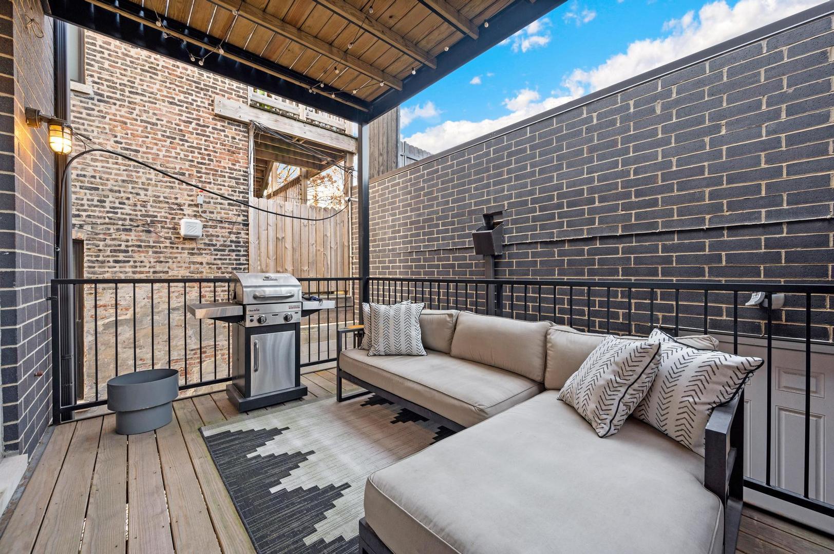 832 West Cullerton Street, Unit 1W Chicago, IL 60608 - Photo 14 of 14 a view of a balcony with chairs and wooden floor