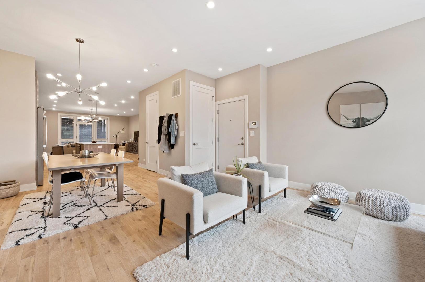 832 West Cullerton Street, Unit 1W Chicago, IL 60608 - Photo 3 of 14 a bedroom with furniture and a chandelier