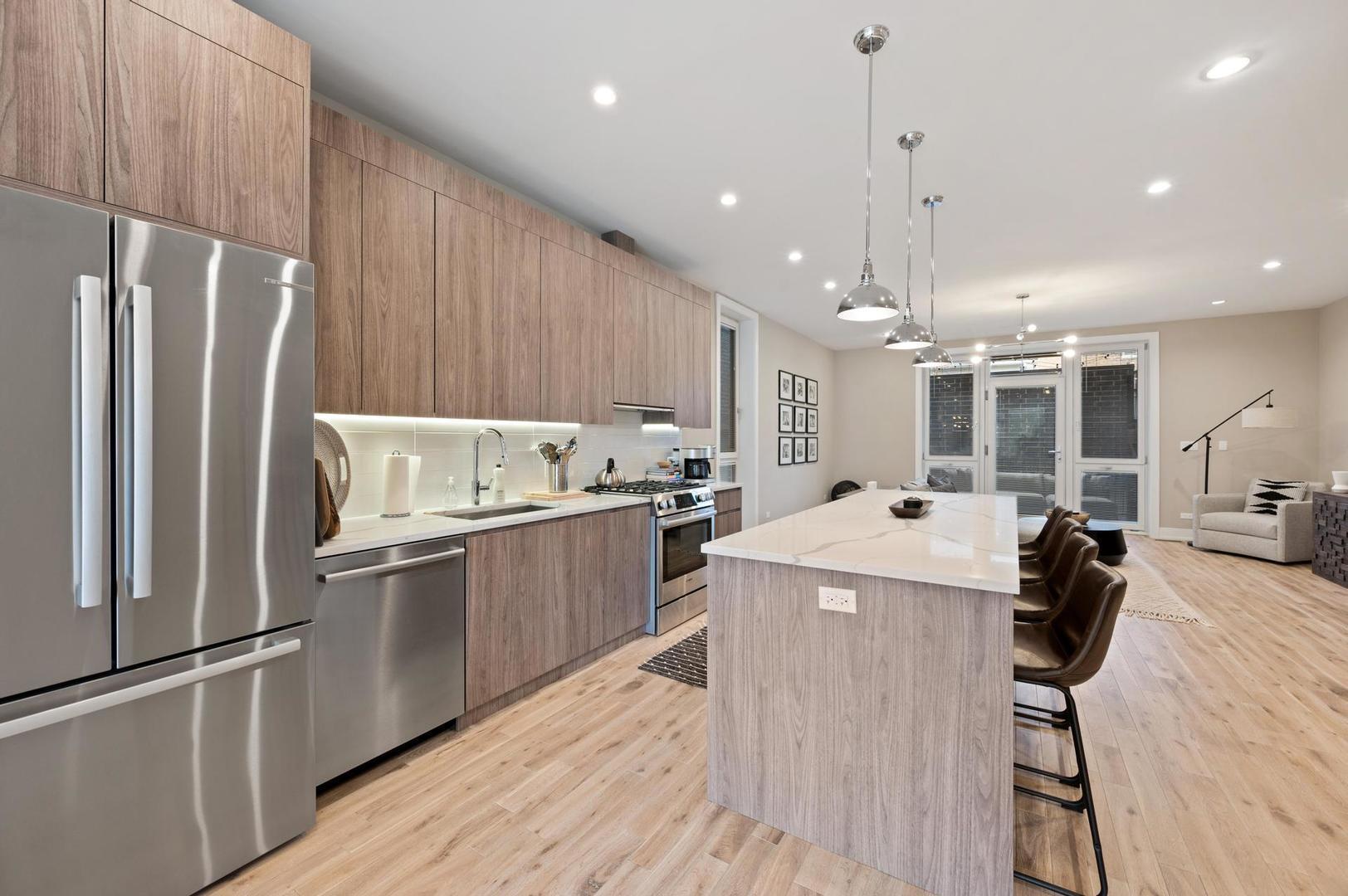 832 West Cullerton Street, Unit 1W Chicago, IL 60608 - Photo 5 of 14 a kitchen with a refrigerator a sink and cabinets