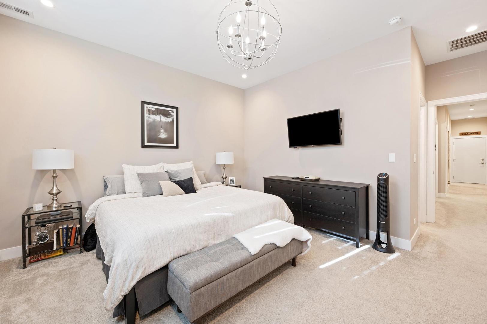 832 West Cullerton Street, Unit 1W Chicago, IL 60608 - Photo 10 of 14 a bedroom with a bed and a flat screen tv