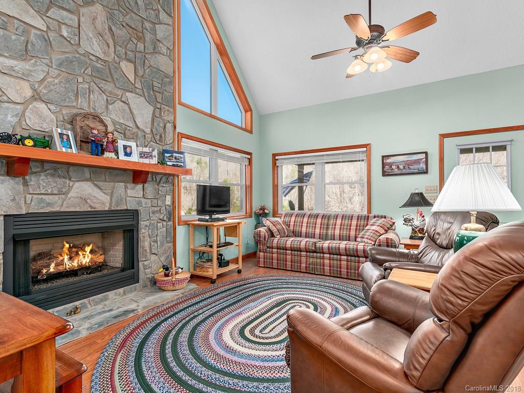 114 Turkey Creek Road Clyde, NC 28721 - Photo 4 of 12 a living room with furniture and a fireplace