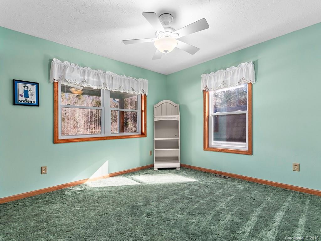 114 Turkey Creek Road Clyde, NC 28721 - Photo 10 of 12 a room that has a bed and a window