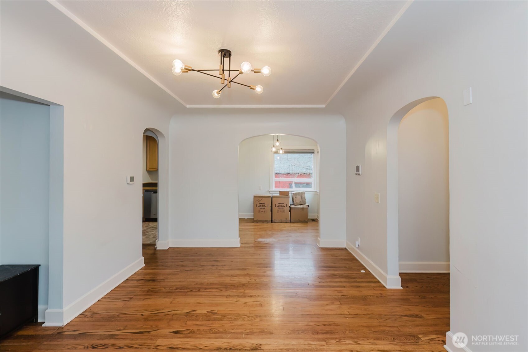 1908 Snyder Avenue Bremerton, WA 98312 - Photo 11 of 35 a view of a livingroom with wooden floor and chandelier