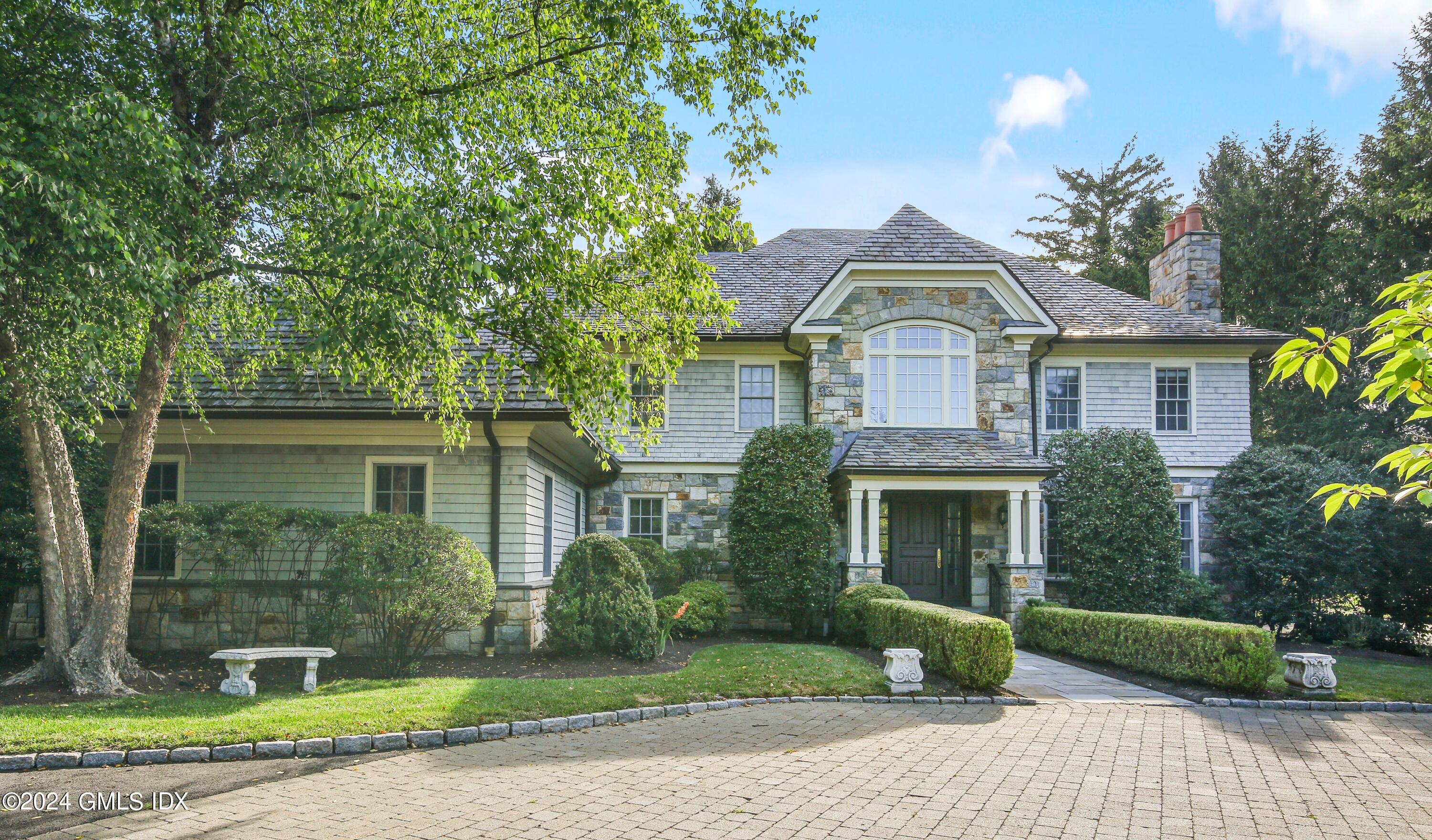 a front view of a house with a garden and plants