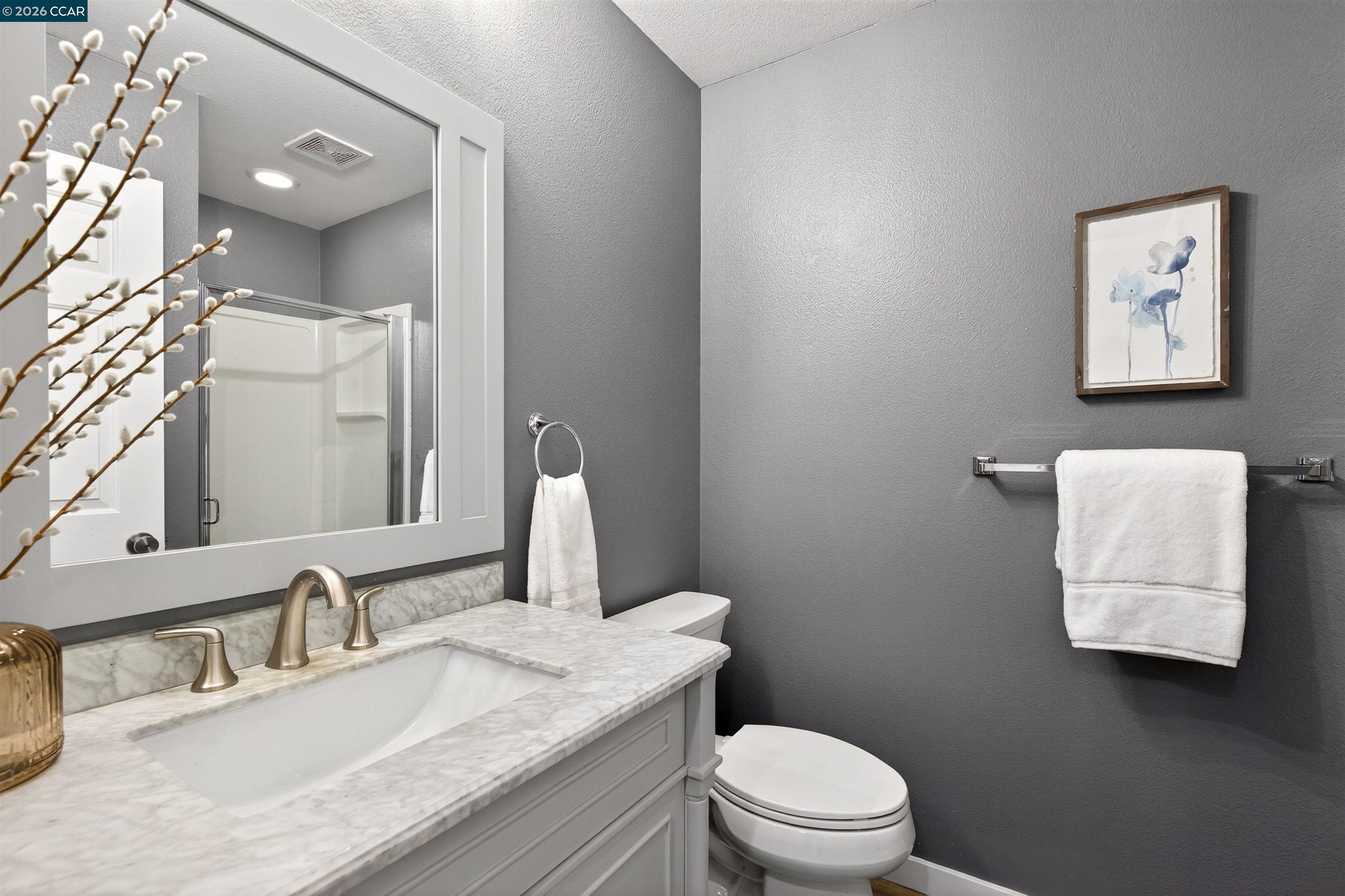 124 Coralflower Lane San Ramon, CA 94582 - Photo 25 of 47 a bathroom with a granite countertop sink mirror vanity and toilet