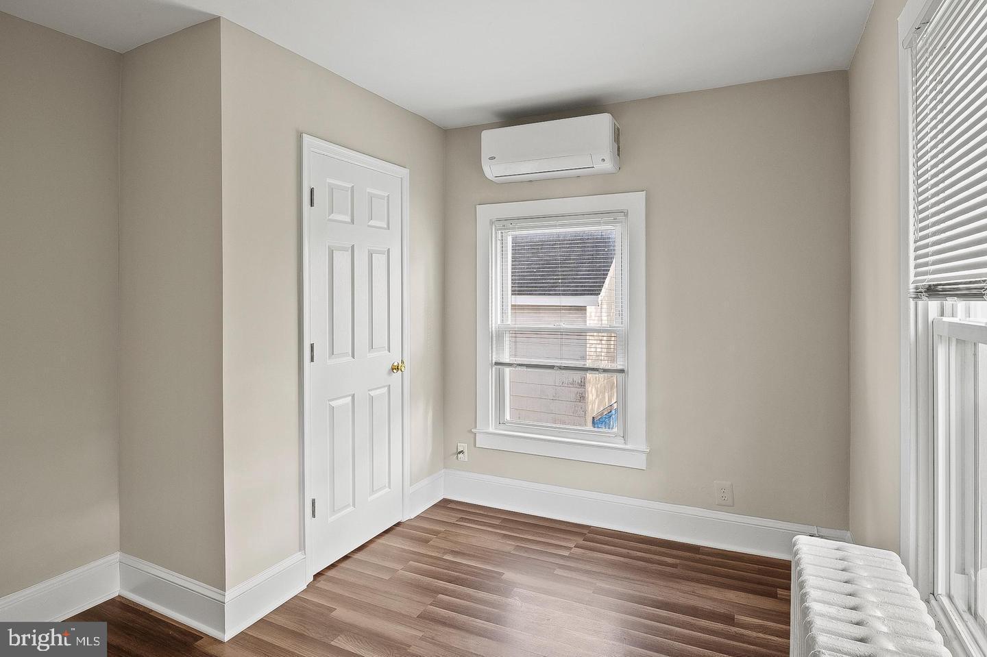 305 9th Street, Unit 4 Laurel, MD 20707 - Photo 14 of 17 a view of an empty room with wooden floor and a window